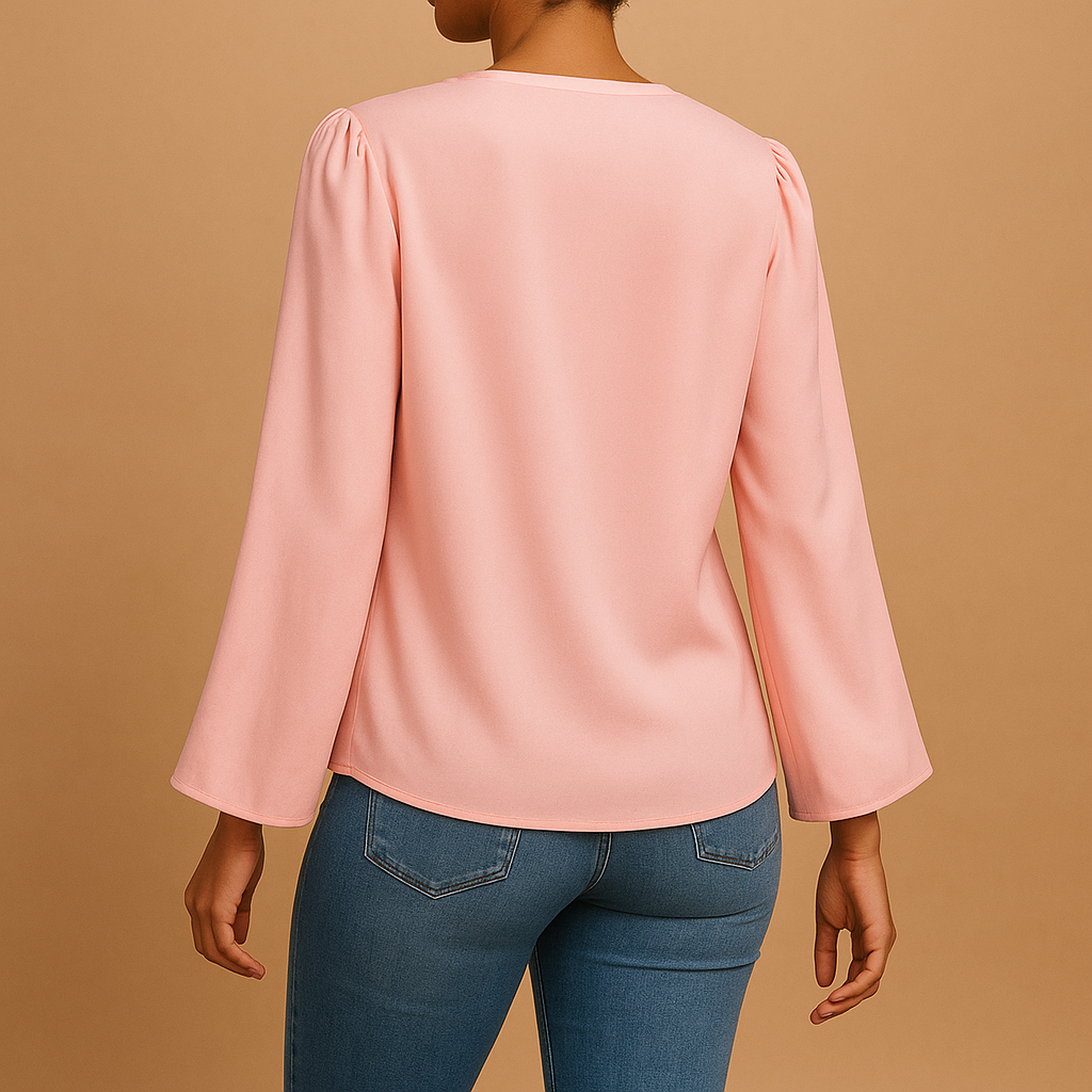 Woman wearing a beige chiffon blouse with puff sleeves and V-neck, ideal for warm weather and stylish summer looks
