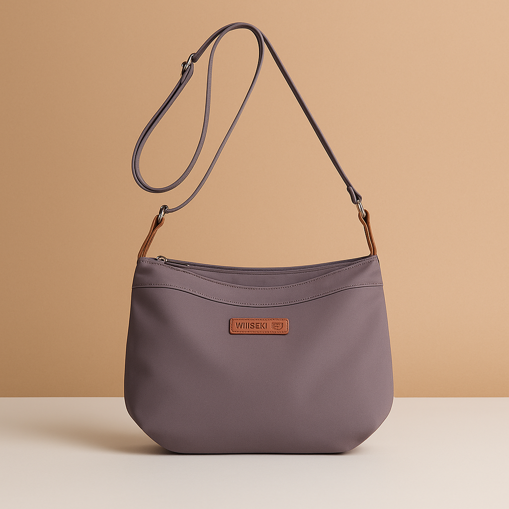 Waterproof anti-theft crossbody travel bag for women with wide strap, secure zip, and functional compartments for commuting or travel.