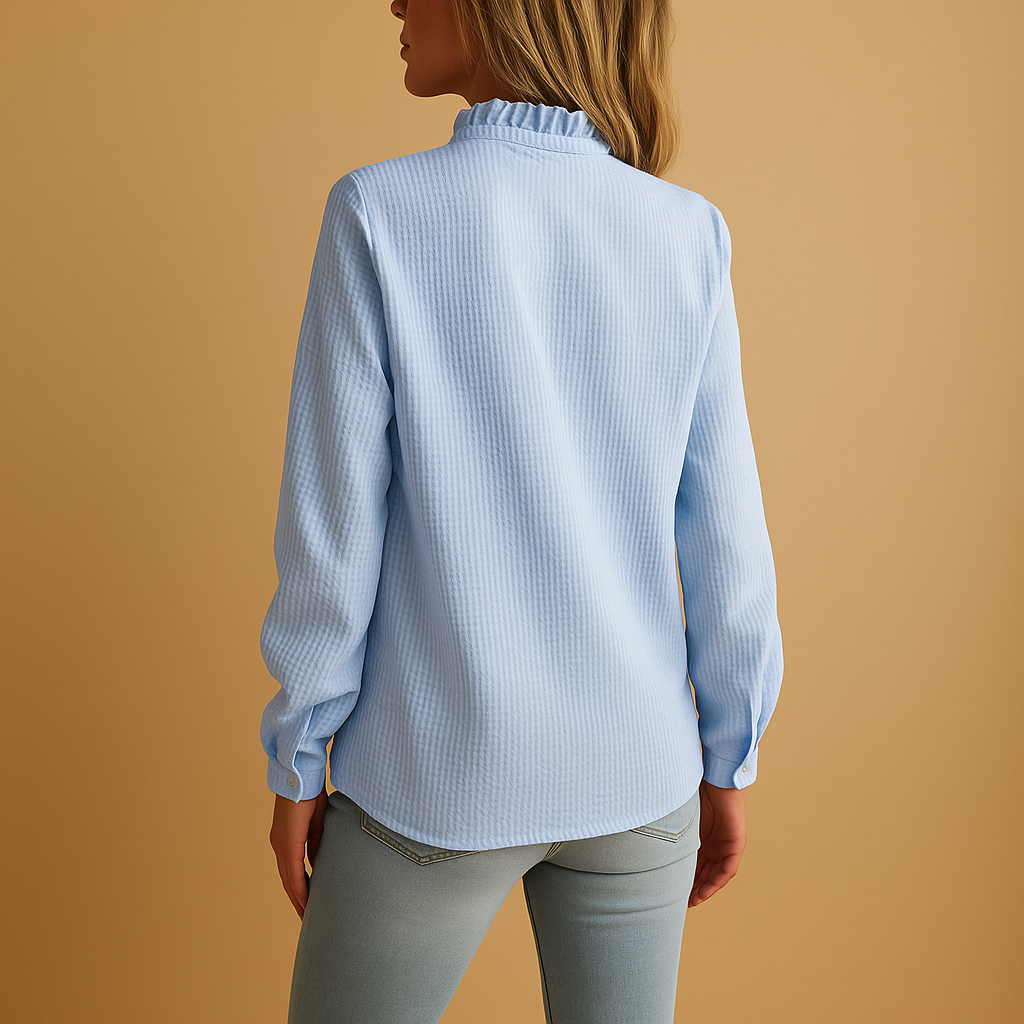 Striped ruffle blouse for women in black, white, pink, or blue with button details and a flattering, feminine fit.