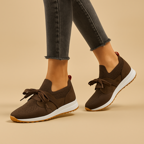Women’s lace-up shoes with breathable mesh, cushioned rubber sole, and rounded toe in black, grey, brown, and red, ideal for daily comfort.