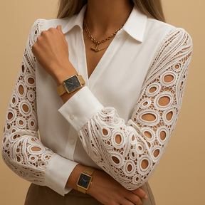 Woman wearing a lace-sleeved blouse with collar and button closure, ideal for formal events or office wear