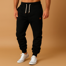 Men’s jogging trousers in a soft cotton blend with adjustable waistband and side pockets, perfect for workouts, casual days, or relaxing at home.