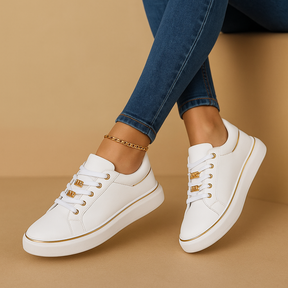 Elegant white sneakers for women with gold heel detail, versatile for casual outfits, travel, and daily wear.