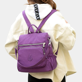 Women’s anti-theft crossbody backpack with hidden zippers, waterproof nylon, and convertible straps—ideal for travel and daily use.