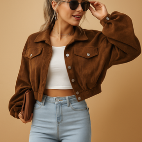 Cropped corduroy jacket for women with long sleeves, chest pockets, silver buttons, and classic collar in ribbed fabric.