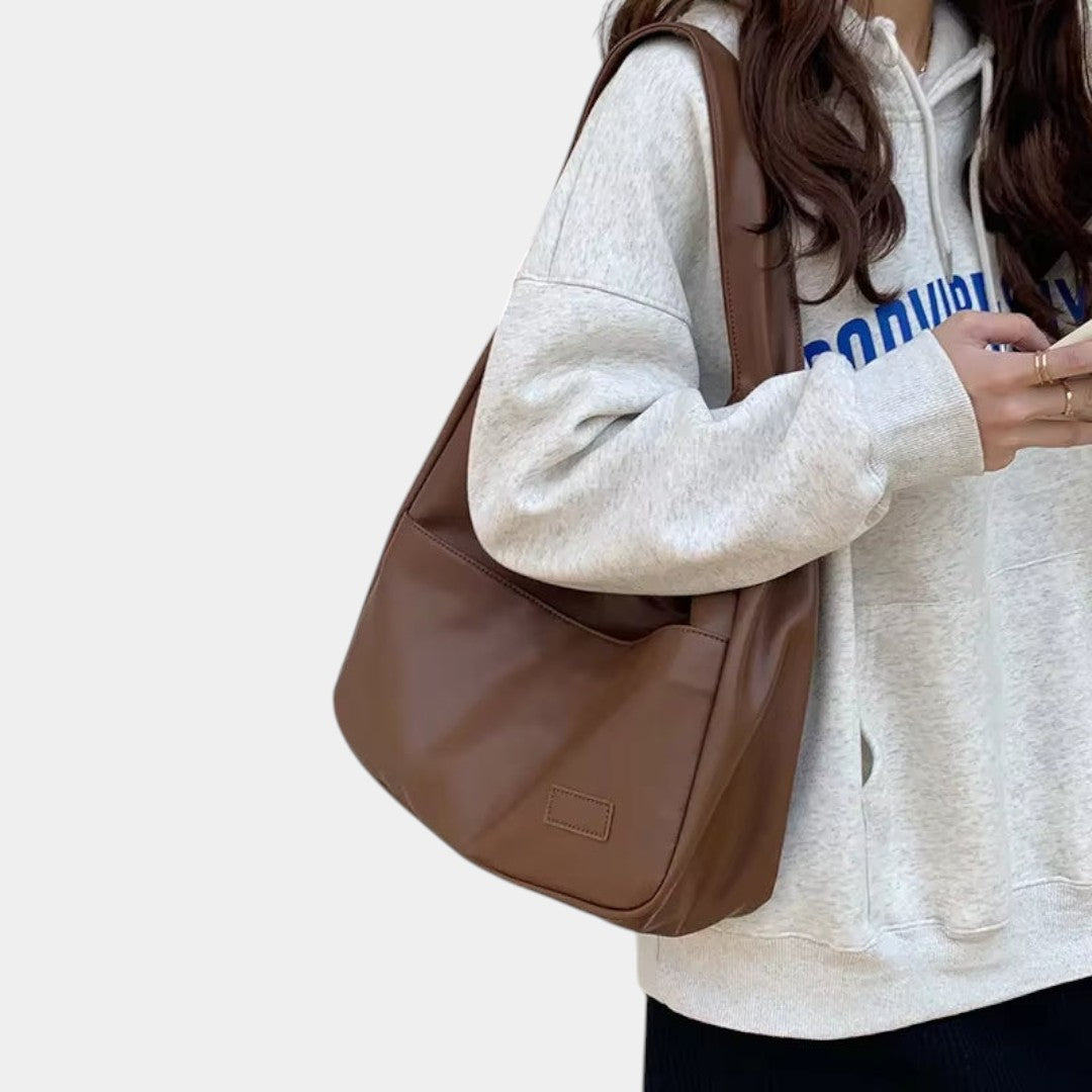 Women’s elegant leather shoulder bag with compartments and adjustable strap, ideal for daily use, work, and formal occasions