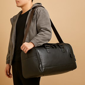 Men’s leather duffle bag with compartments, water-resistant finish, padded strap, and sleek design for travel and work.