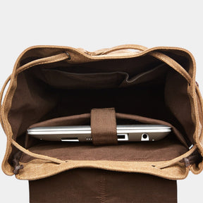 Men’s canvas travel backpack with padded laptop sleeve, drawstring and magnetic closures, ideal for work, hiking, or everyday use