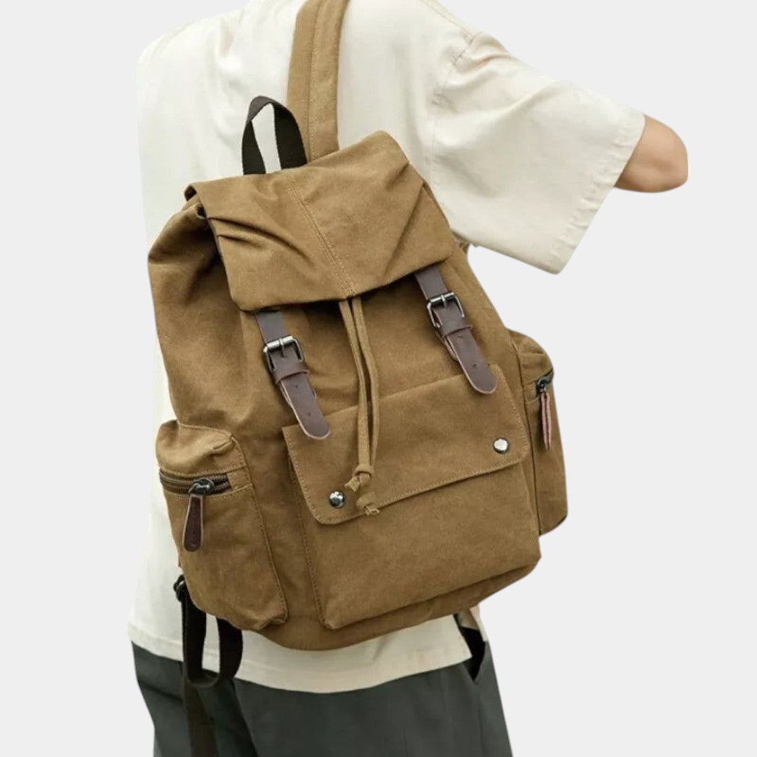 Men’s canvas travel backpack with padded laptop sleeve, drawstring and magnetic closures, ideal for work, hiking, or everyday use
