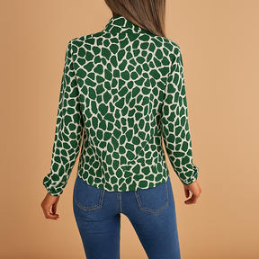 Elegant green polka dot blouse for women with bow detail and elastic cuffs, perfect for both work and everyday style.