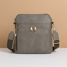 Women's RFID crossbody bag with anti-theft pocket and water-resistant faux leather exterior, convertible to clutch with tassel detail
