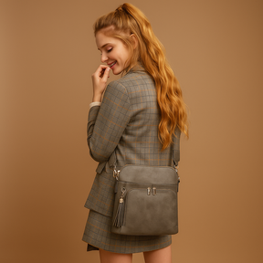 Women's RFID crossbody bag with anti-theft pocket and water-resistant faux leather exterior, convertible to clutch with tassel detail