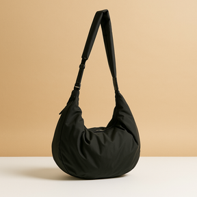 Spacious puffer crossbody bag for women with water-resistant finish, thick shoulder strap, and roomy interior—ideal for travel and everyday use.