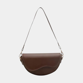 Women’s vintage saddle crossbody bag with adjustable strap, secure compartments, and elegant flap design for everyday use