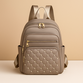 Water-resistant women’s backpack with anti-theft back pocket, adjustable straps, and spacious compartments, perfect for travel or everyday use.
